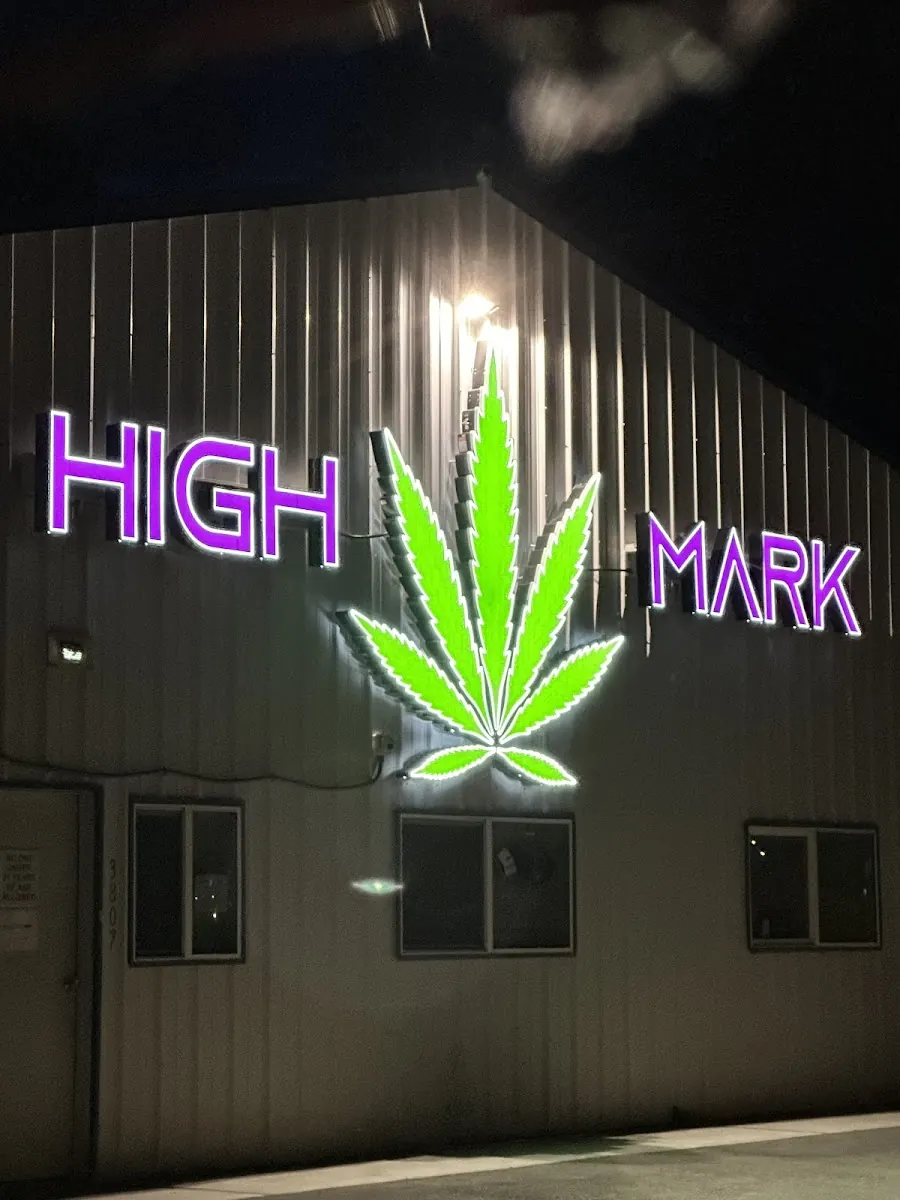 The High-Mark Cannabis sign at night on W Machen Rd